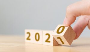 New year 2020 change to 2021 concept. Hand flip over wood cube block