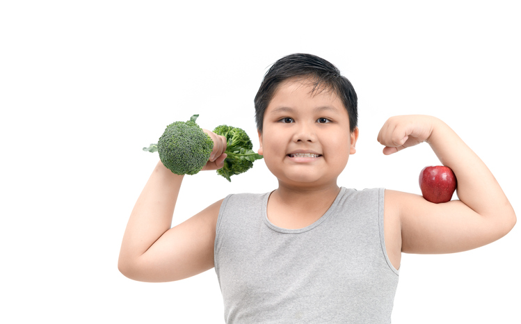 Boy holding a broccoli dumbbell