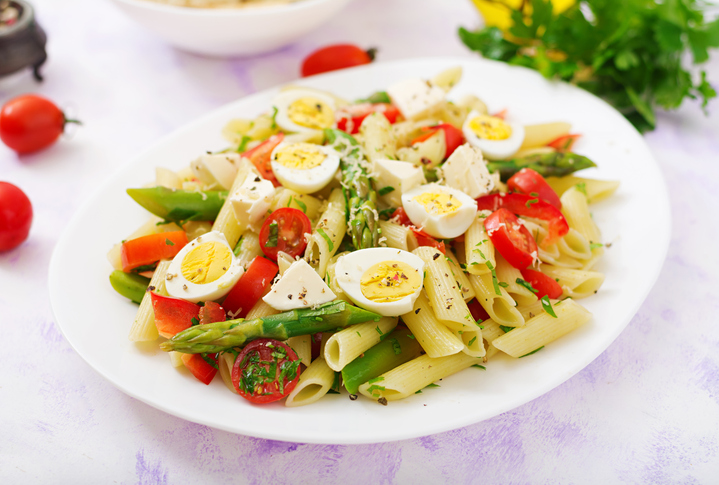 Salad - penne pasta with asparagus, tomatoes, quail eggs, mozzarella