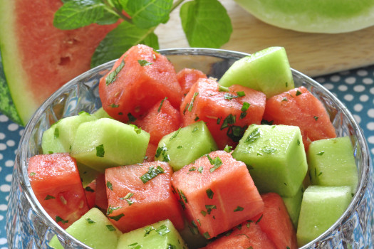 watermelon and honeydew melon in a bowl with chopped mint