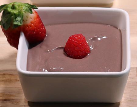 bowl with chocolate mousse with strawberry and raspberry garnish