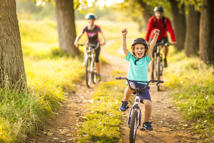 Happy family cycling in the countryside