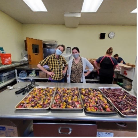 People wearing masks in a kitchen