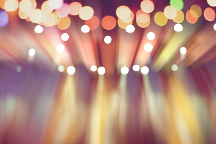 blurred lights on stage, abstract image of colourful lighting, background party blur celebration concept.