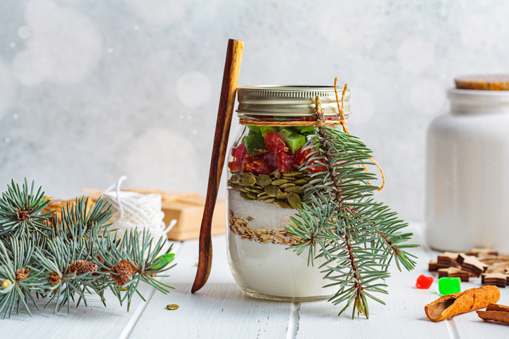 Christmas cookie mix jar. Dry ingredients for making Christmas cookies in a jar, white background.