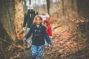 Family of four hiking in the woods.