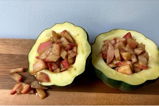 Apple-stuffed squash displayed on a wooden table