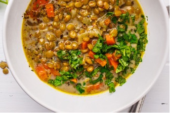 Lentil soup in a white bowl.