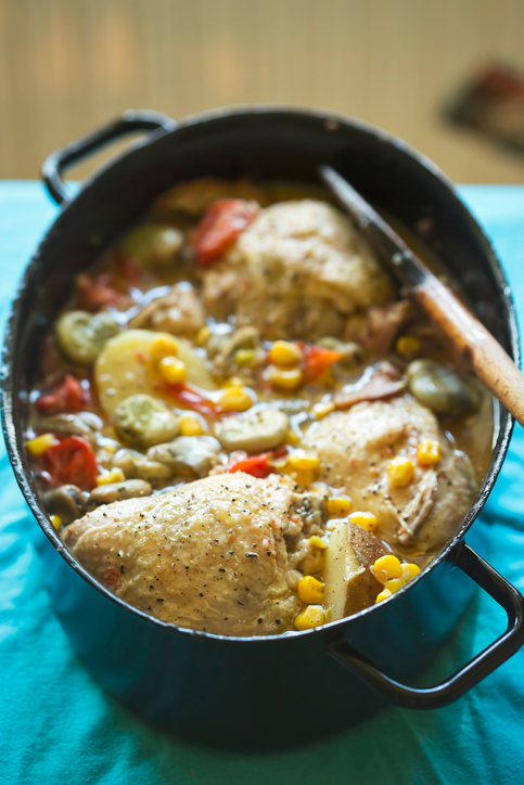 Summer chicken one pot with vegetables: potatoes, tomatoes, corn, broad beans