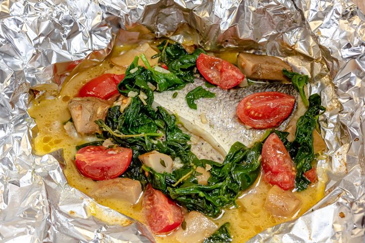 Fish in Foil with Cherry Tomato, Onions and Vegetables.