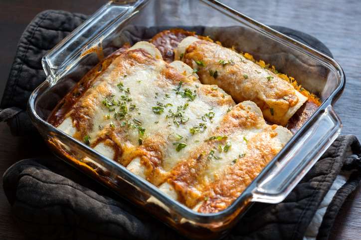 Vegetarian Enchiladas in a red sauce filled with beans and vegetables and smothered with cheese.
