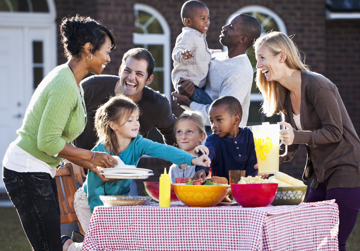 Two families with children having picnic.