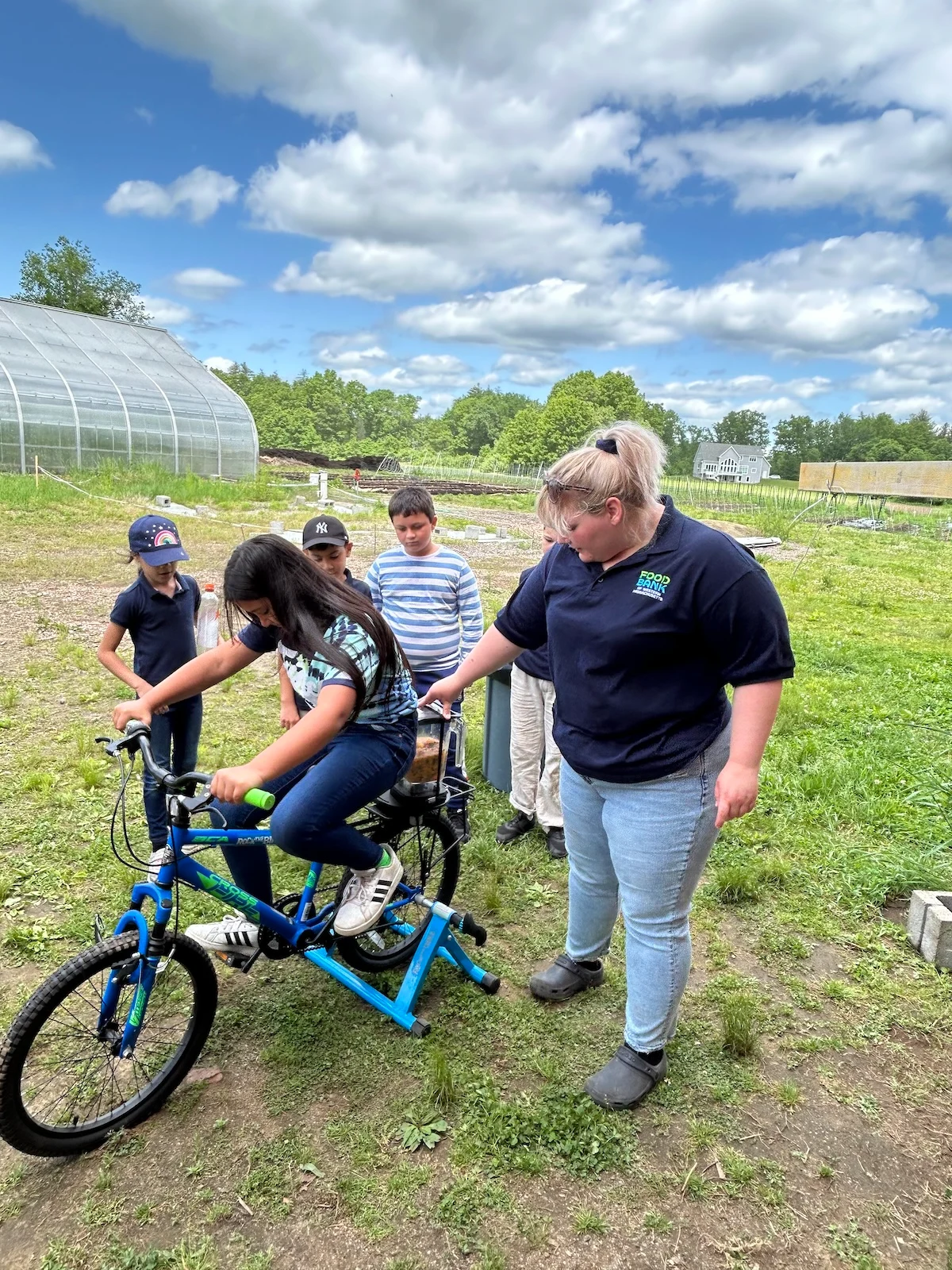 Kids riding a stationary bike on a farm