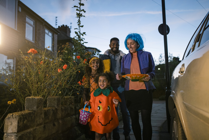 A Family Trick or Treating at Dusk