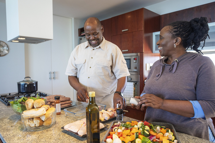 Senior African Couple Having Fun Cooking Together