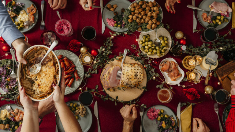 Typical swedish scandinavian christmas smörgåsbord buffet food Photo taken from above overhead table top shot Photot of typical smorgasbord with breaded ham, meatballs, sausauge,noisette, pickled herring and side dishes Julbord med griljerad skinka sill och lax