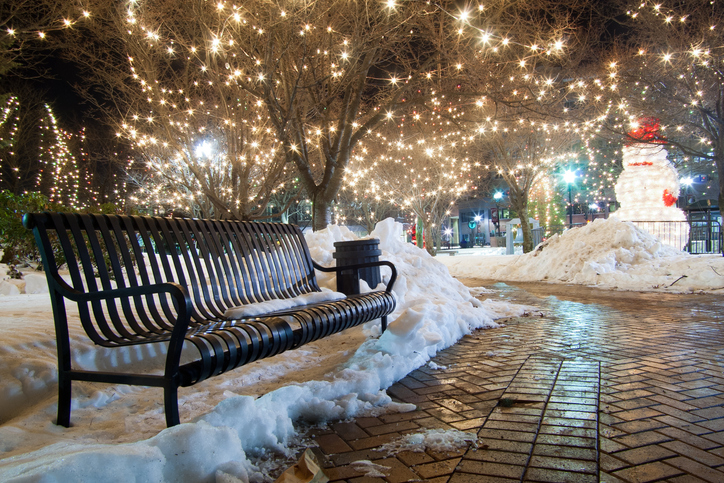 Snow covers the ground in this park, with Frosty waving hello.