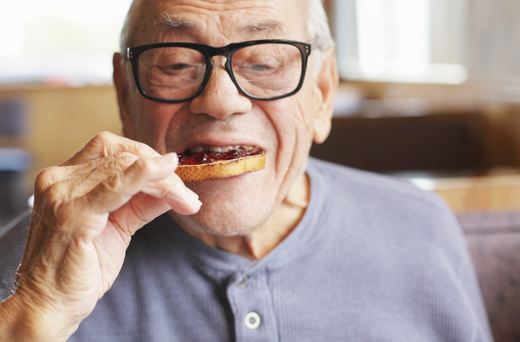 Senior Man Eating Toast and Jelly Jam.