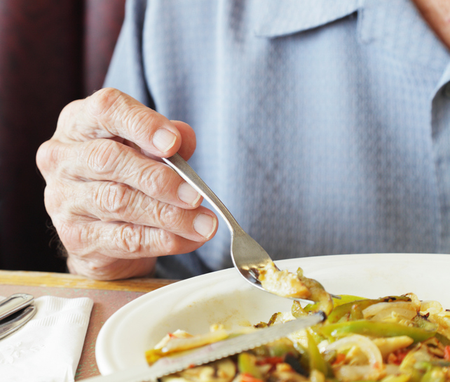 Senior Man Fingers Holding Breakfast Fork 