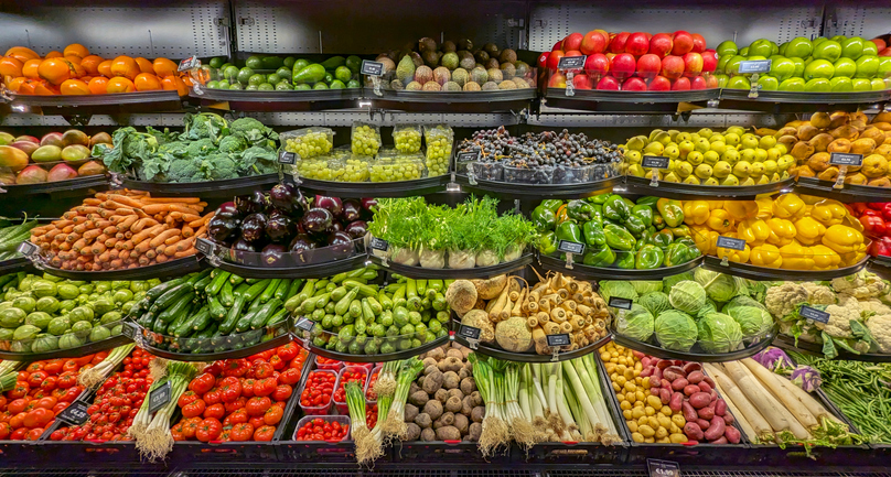 Neatly organized assortment of vibrant fresh fruits and vegetables in grocery store fresh Fruits and Vegetables section