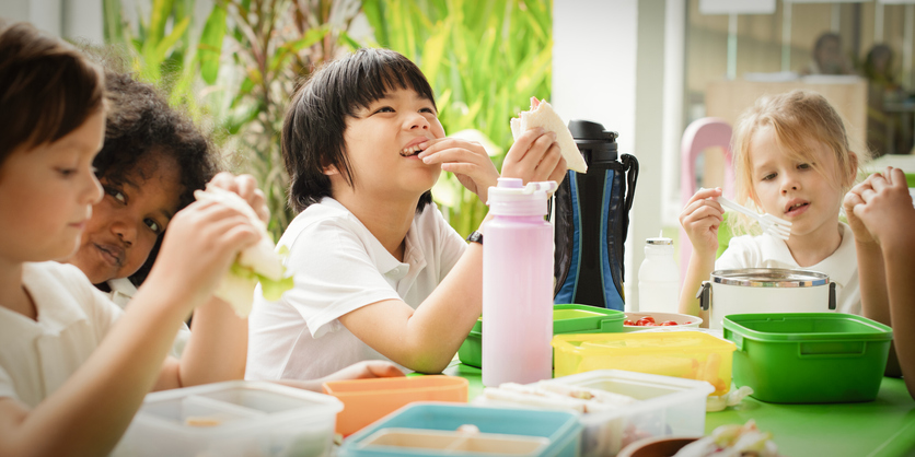 Children enjoying lunch together at a table.