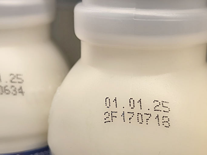 Select focus of the expiration date stamped on milk bottle. Expire date. Dairy product