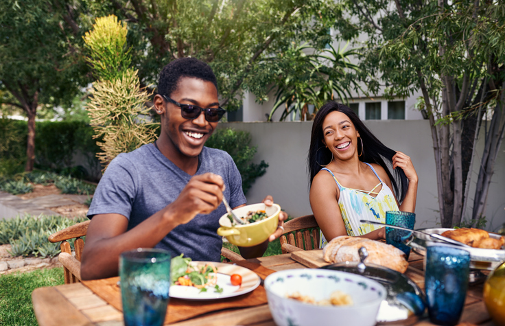 Shot of a happy family having lunch out in the backyard