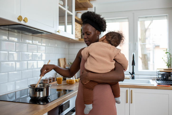 Cooking with sleeping baby boy