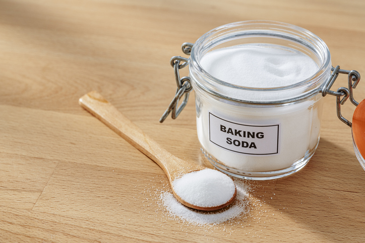 Baking soda in a glass jar and spoon