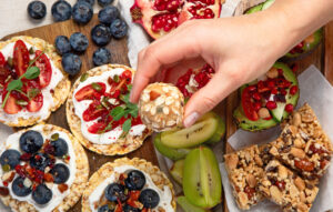 Healthy Snack Platter with fruits, nuts and dried fruits. Gourmet organic food, clean eating, plant-based protein, vegan diet. Top view.