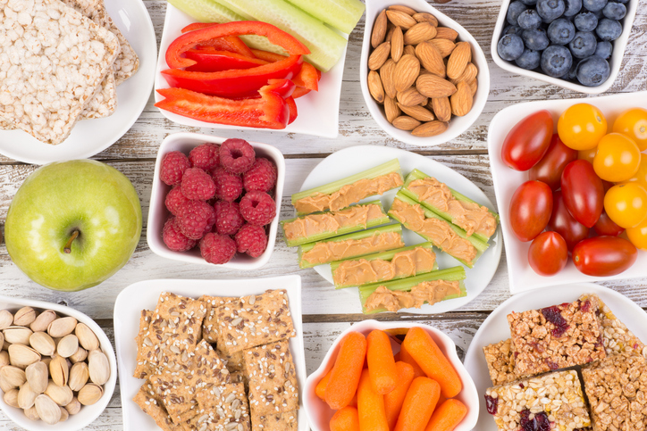 Healthy snacks on wooden table, top view